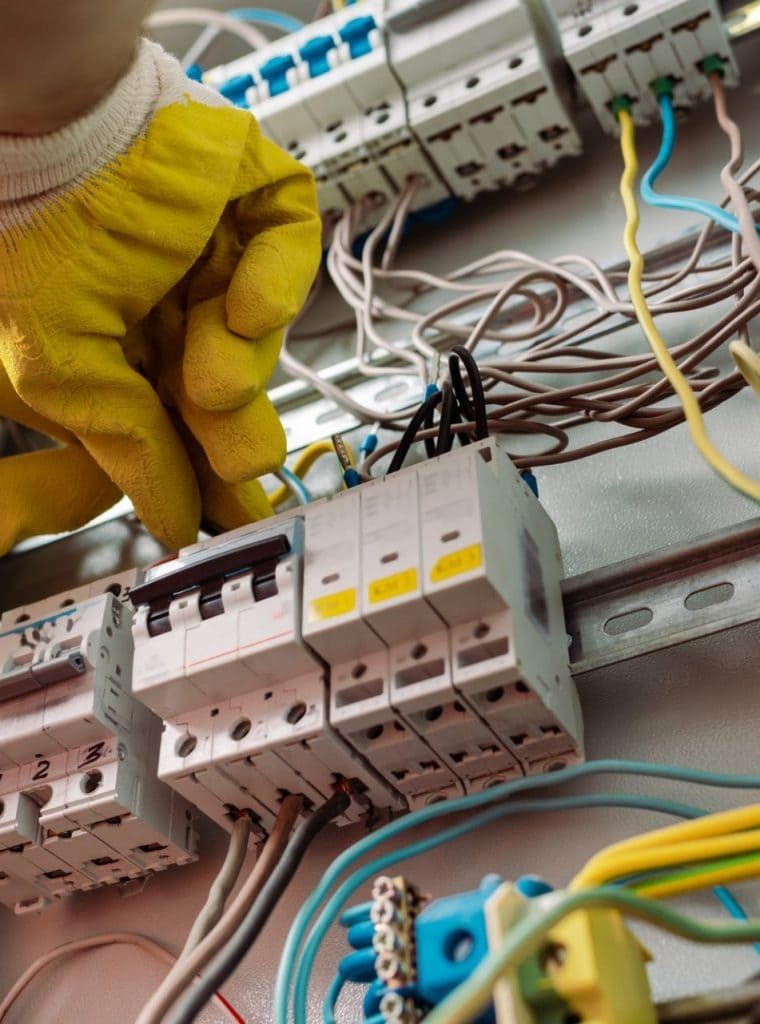 low-angle-view-of-electrician-in-gloves-fixing-electrical-distribution-box-e1624860007883-p9bghdhkylh4glyn53sabhlkflzef1vyokfz0i98n4 (1)